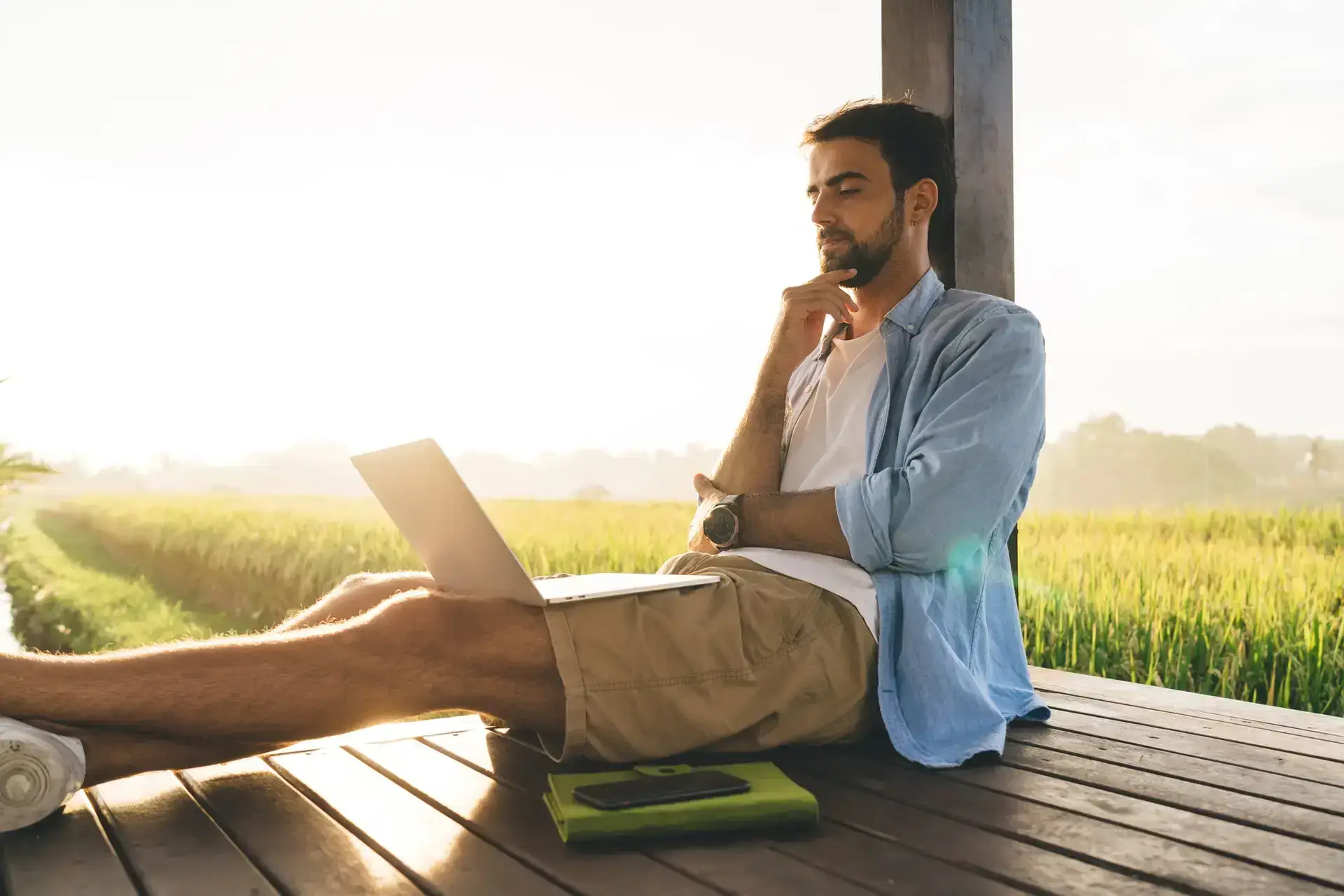 Ponder male freelancer browsing laptop in nature